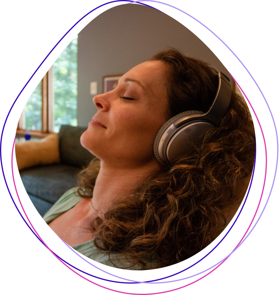 Young Woman Meditating with Headphones on Couch