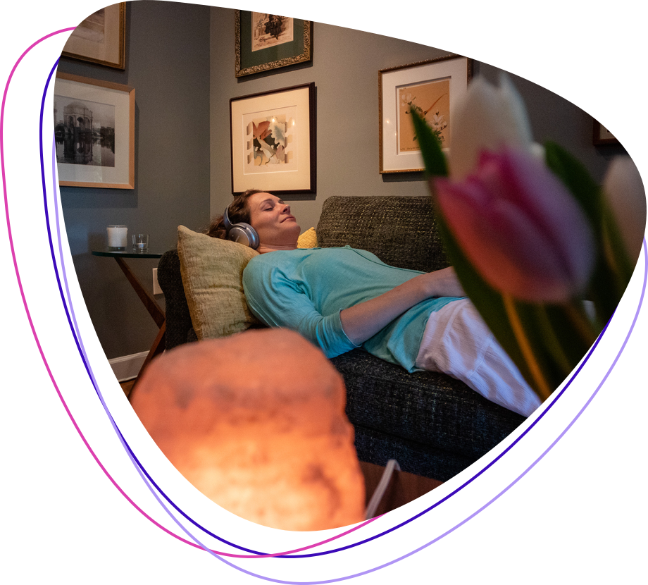 Young Woman Meditating with Headphones on Couch