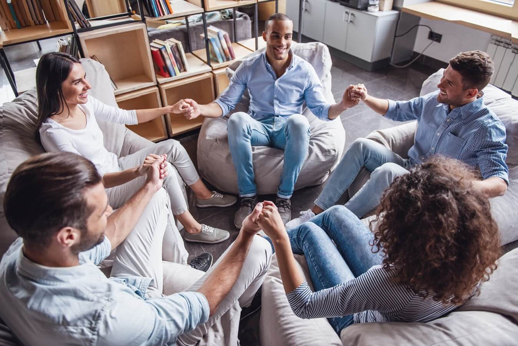 group of people holding hands in a circle